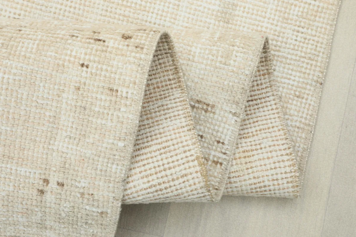 The runner rug folded to showcase its flexibility and the detailed knotting on the reverse side.