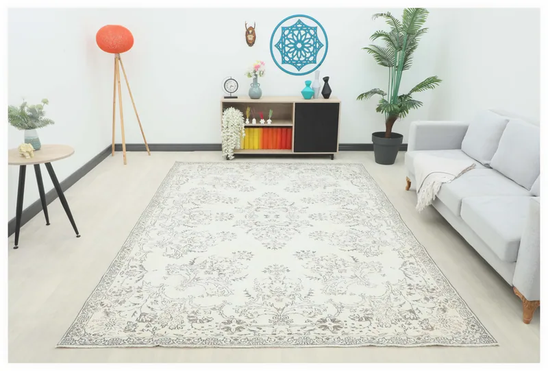 Full overhead view of the 7'2" x 10'0" vintage Anatolian area rug with ivory field and gray patterns.