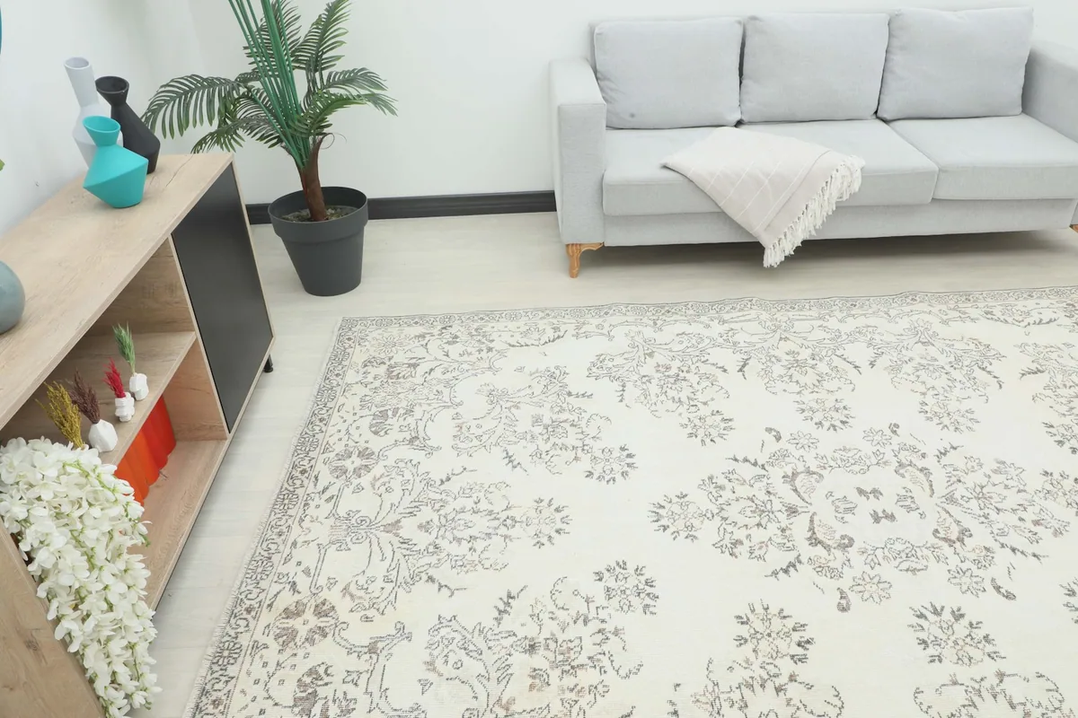 Angle view of the large ivory and gray area rug in a room with modern furniture.