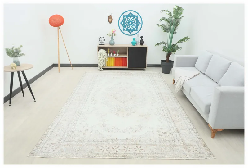 Full overhead view of the 6'11" x 10'9" ivory and beige vintage Anatolian area rug on a white background.