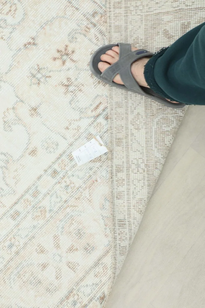 Overhead view of the rug's reverse side, showing the tightly woven cotton foundation and hand-knotted structure.