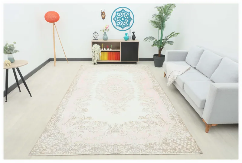 Full overhead view of the rose and ivory floral medallion rug on a white background