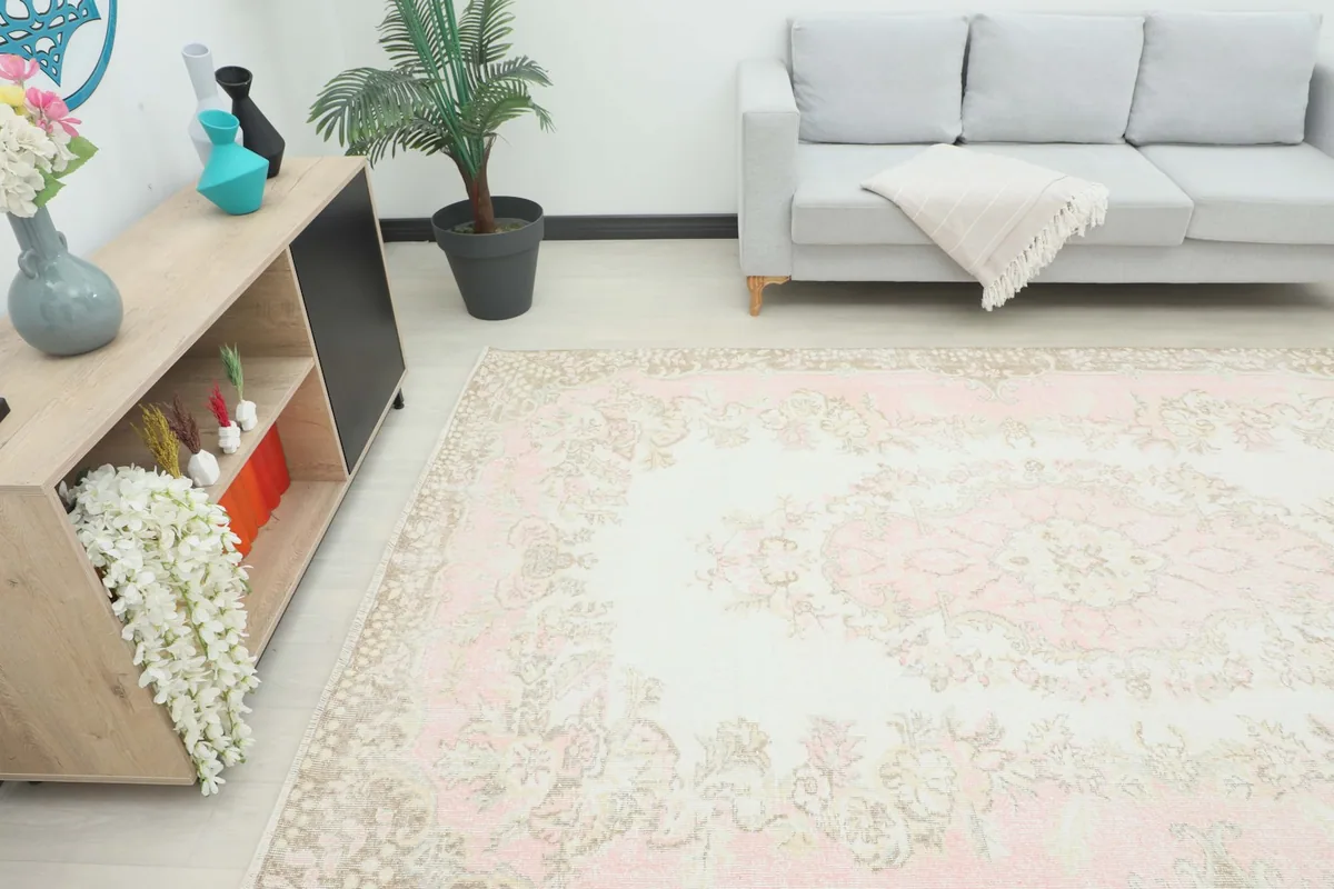 Angle view of the rug in a living room, showing its scale next to a sofa and console