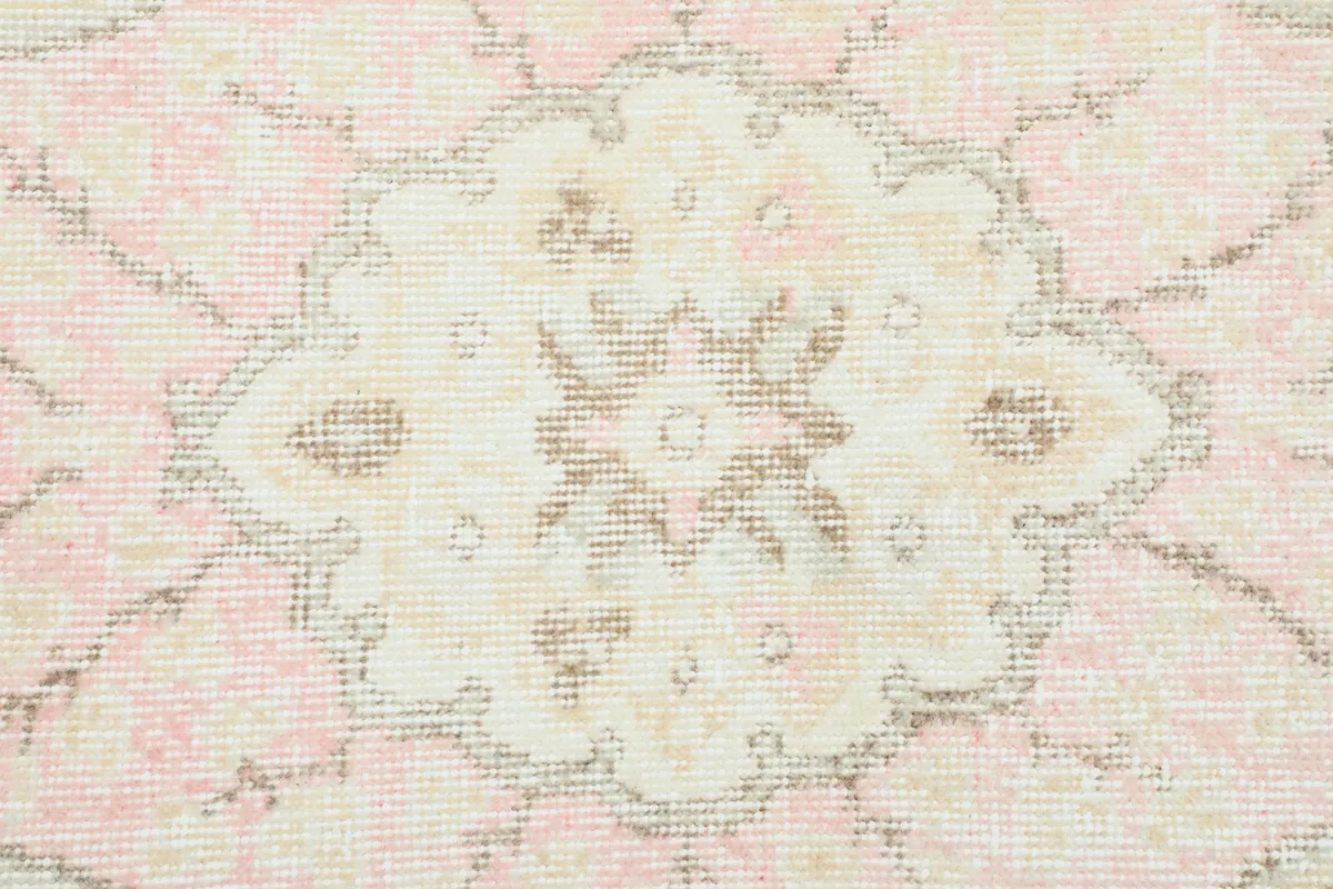 Close-up of the intricate patterns within the central medallion of the rug