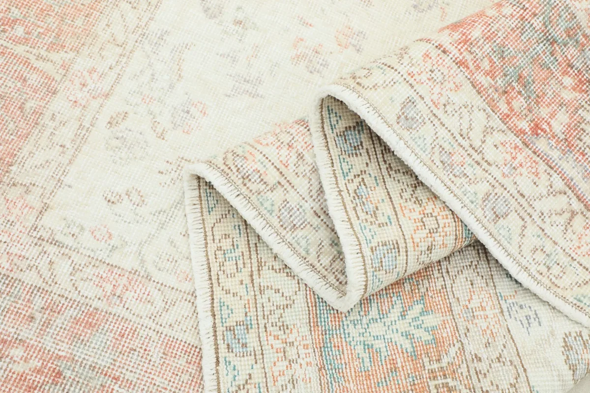 Folded section of the rug showing the thickness and the intricate back weave