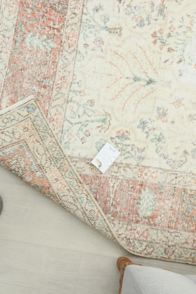 Partial view of the rug with a label, showing its authentic vintage condition