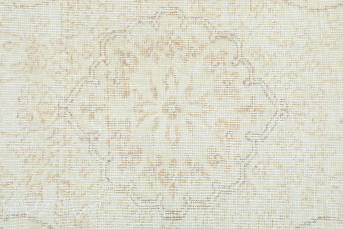 Close-up of the central medallion motif, highlighting the subtle design and low pile.