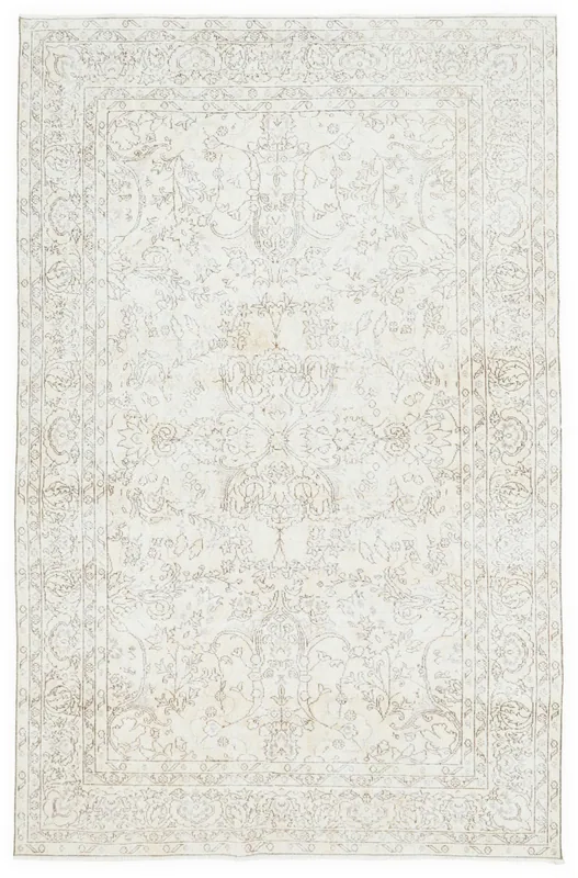 Full overhead view of the ivory and tan floral medallion vintage Anatolian area rug.