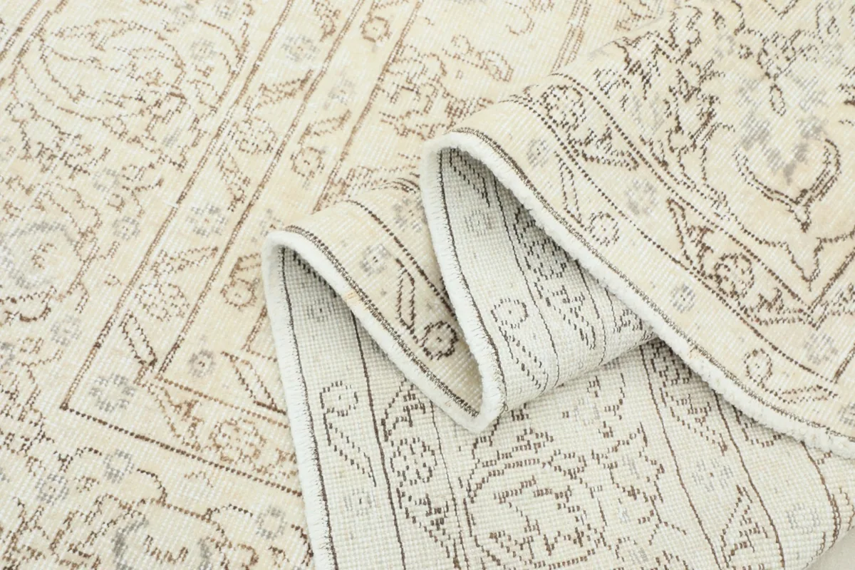 Folded section of the rug, showcasing the flexible drape and thickness of the material.
