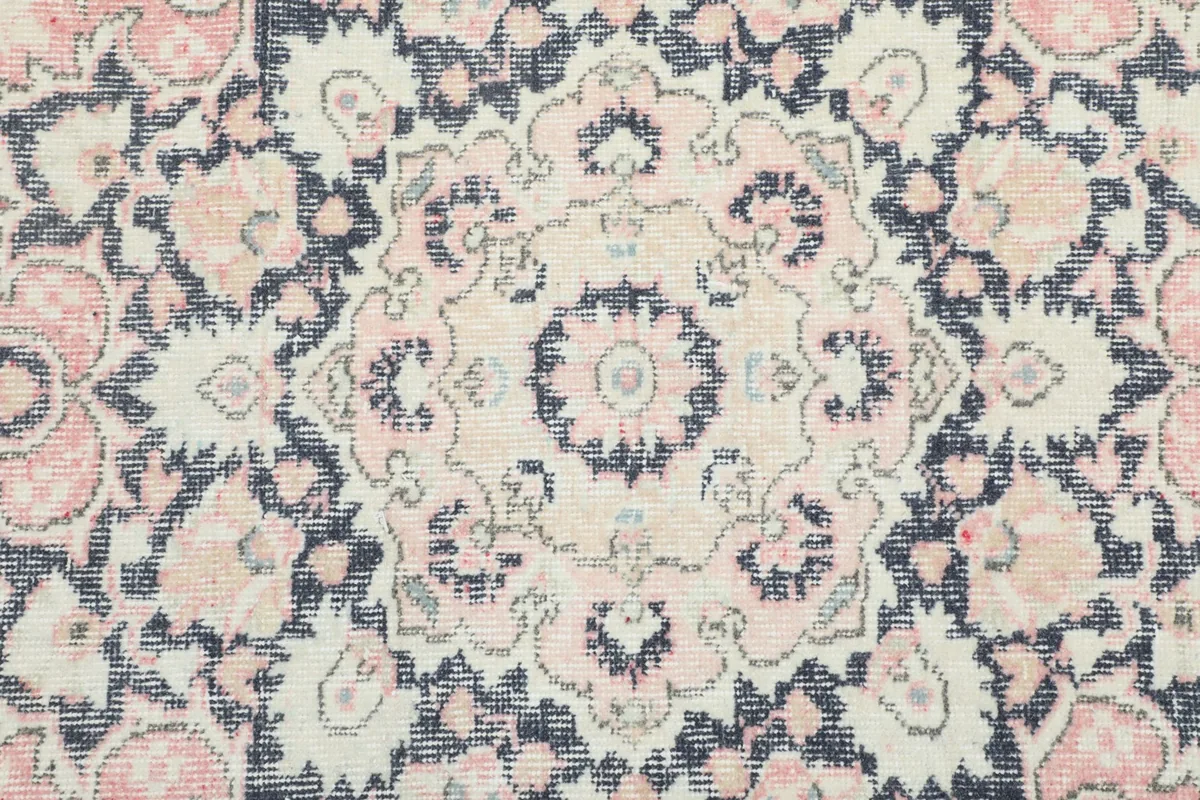 Close-up of the rug's central medallion, highlighting the detailed floral motifs