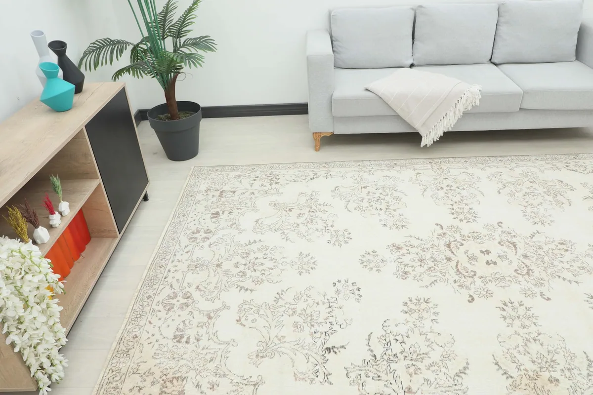 Angle view of the ivory beige rug in a room, showing its scale relative to furniture.