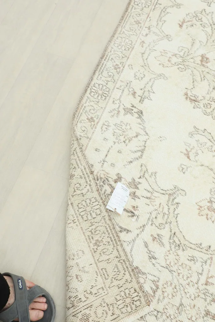 View of the rug's underside, showing the cotton foundation and hand-knotted structure.