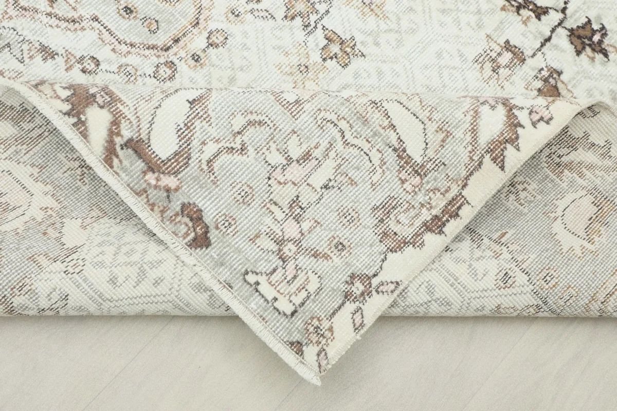Folded corner revealing the back of the hand-knotted wool pile on cotton foundation
