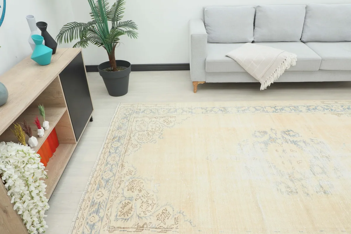 Angle view of the large ivory and blue vintage area rug in a living space