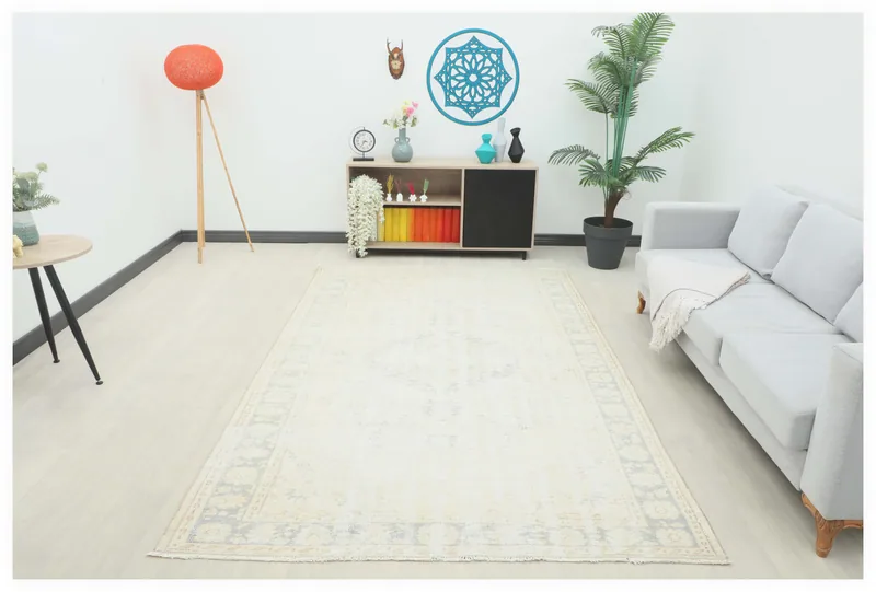 Full overhead view of the 6x9 vintage Anatolian rug with an ivory and gray medallion design