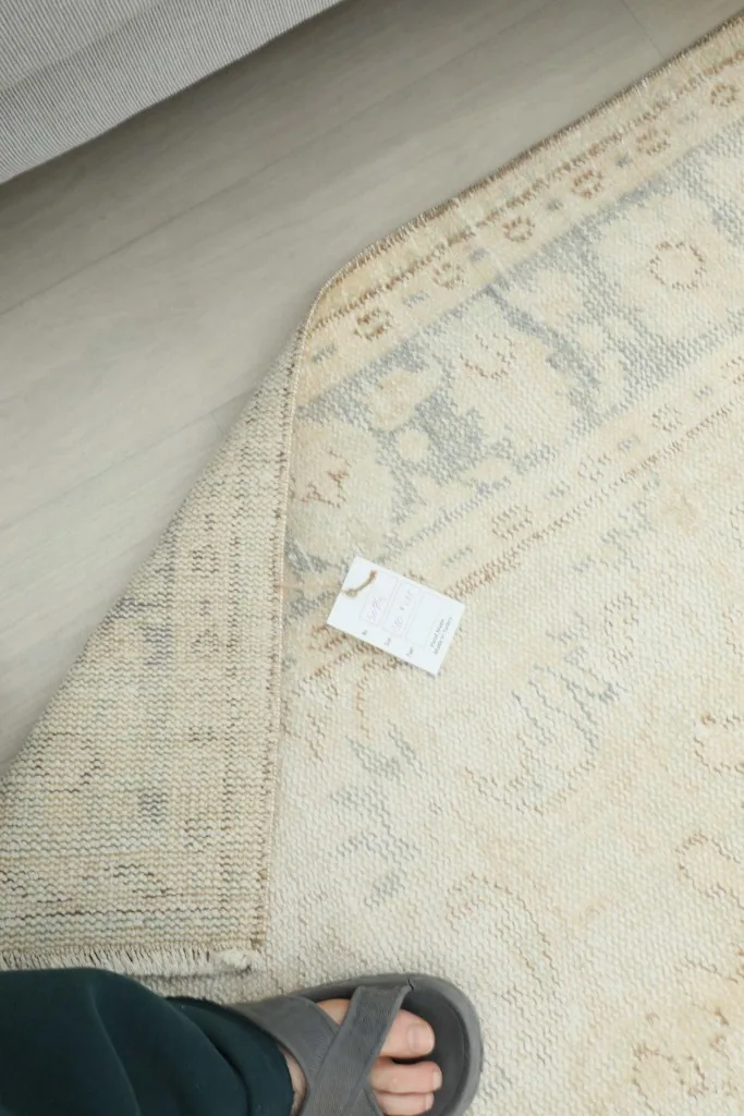 Overhead view of the rug's underside, showing the cotton foundation and hand-knotted structure
