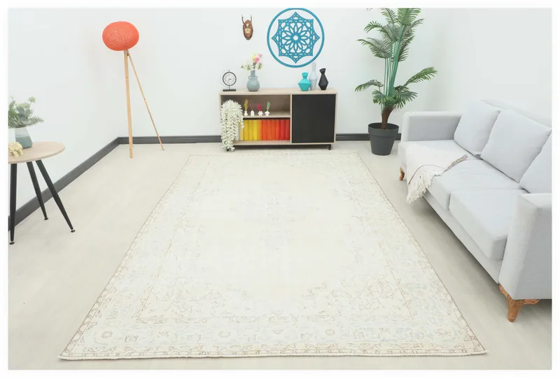 Full overhead view of the ivory floral medallion vintage Anatolian area rug