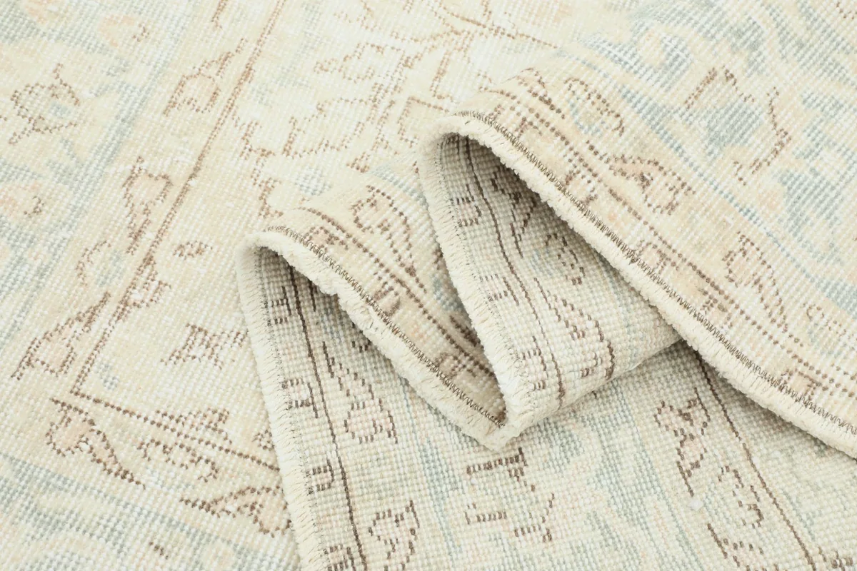 Rolled section of the rug showing the thickness of the hand-knotted wool pile