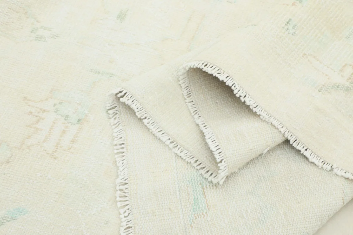Close-up of the low wool pile texture and the tightly woven structure of the rug