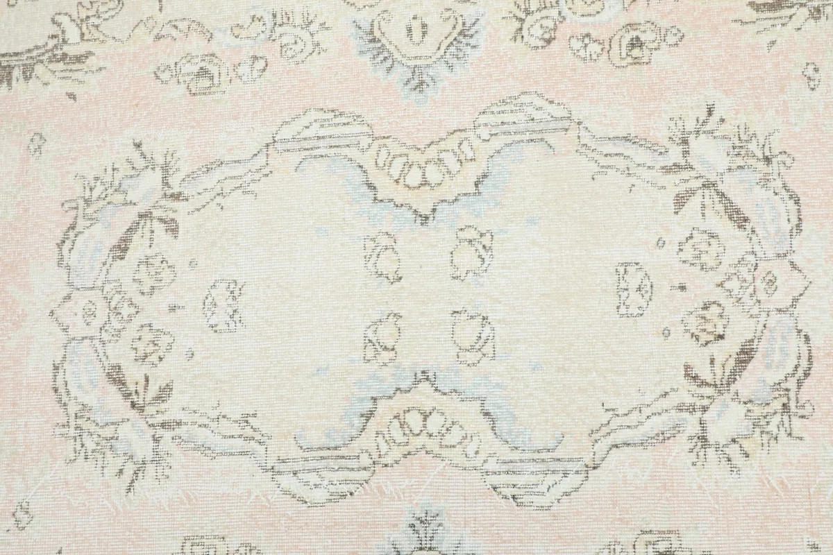 Detailed view of the central medallion and surrounding floral motifs on the rug