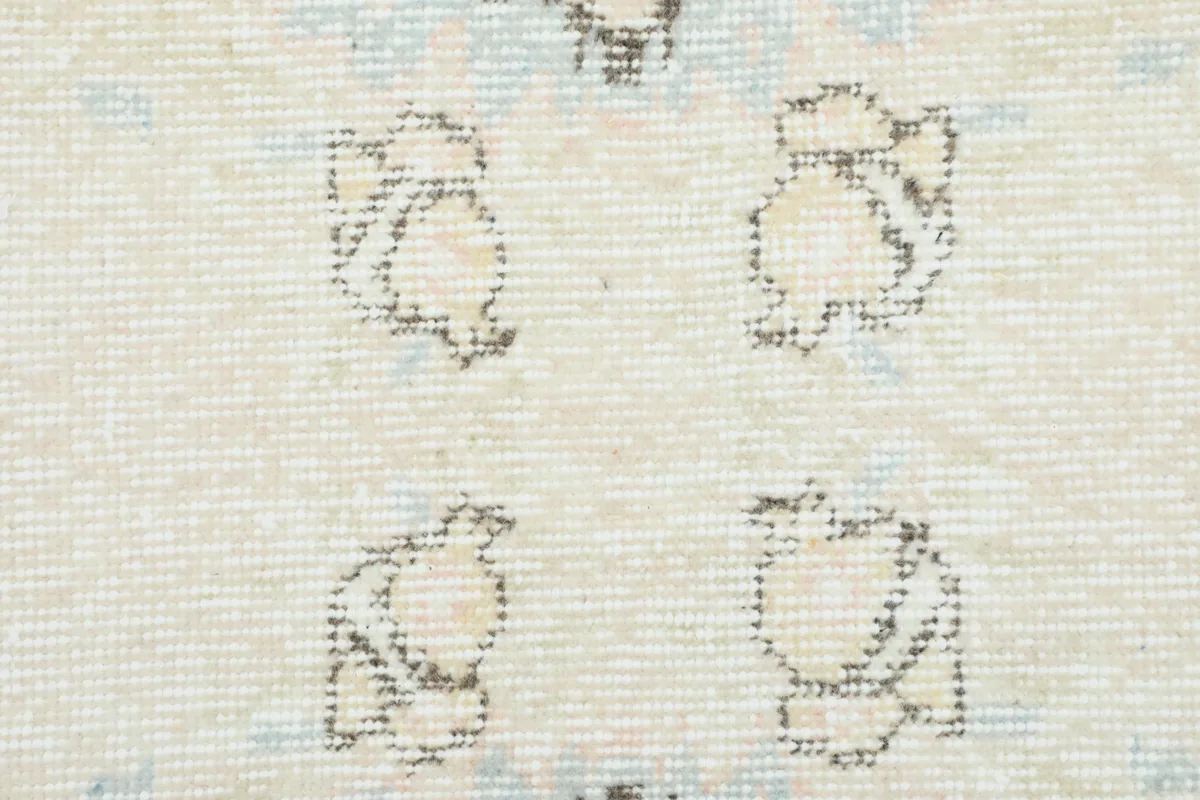 Close-up texture of the hand-knotted wool pile showing subtle color variations