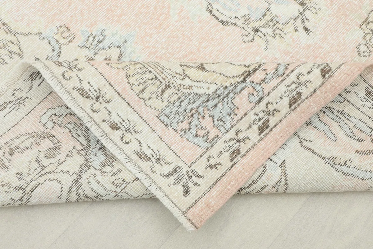 Corner of the rug folded back to show the reverse side and construction details