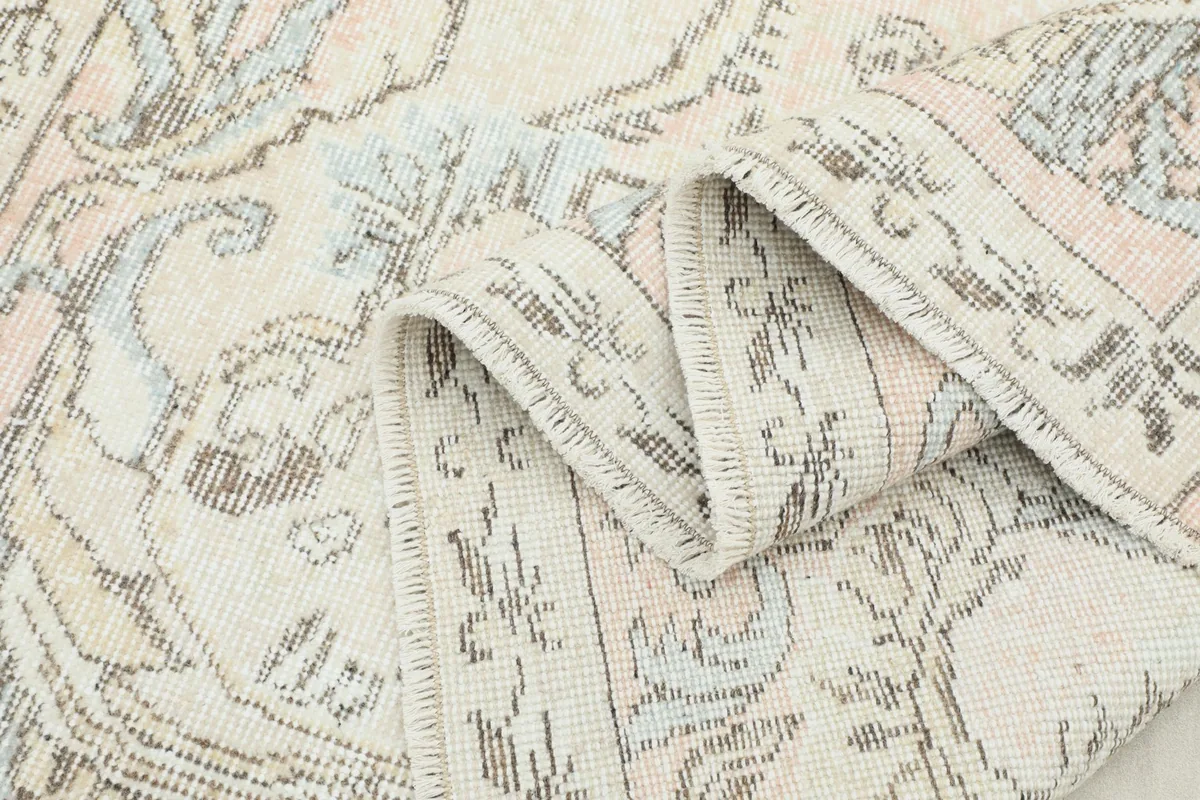 Rug partially folded, displaying its flexibility and the intricate patterns
