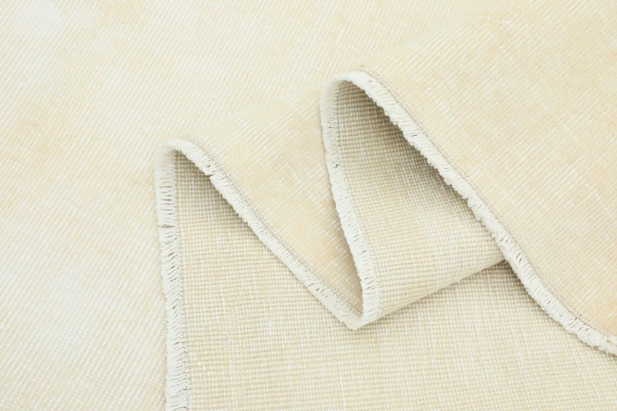 Close-up of a folded edge of the rug, showing the pile and the neat finish