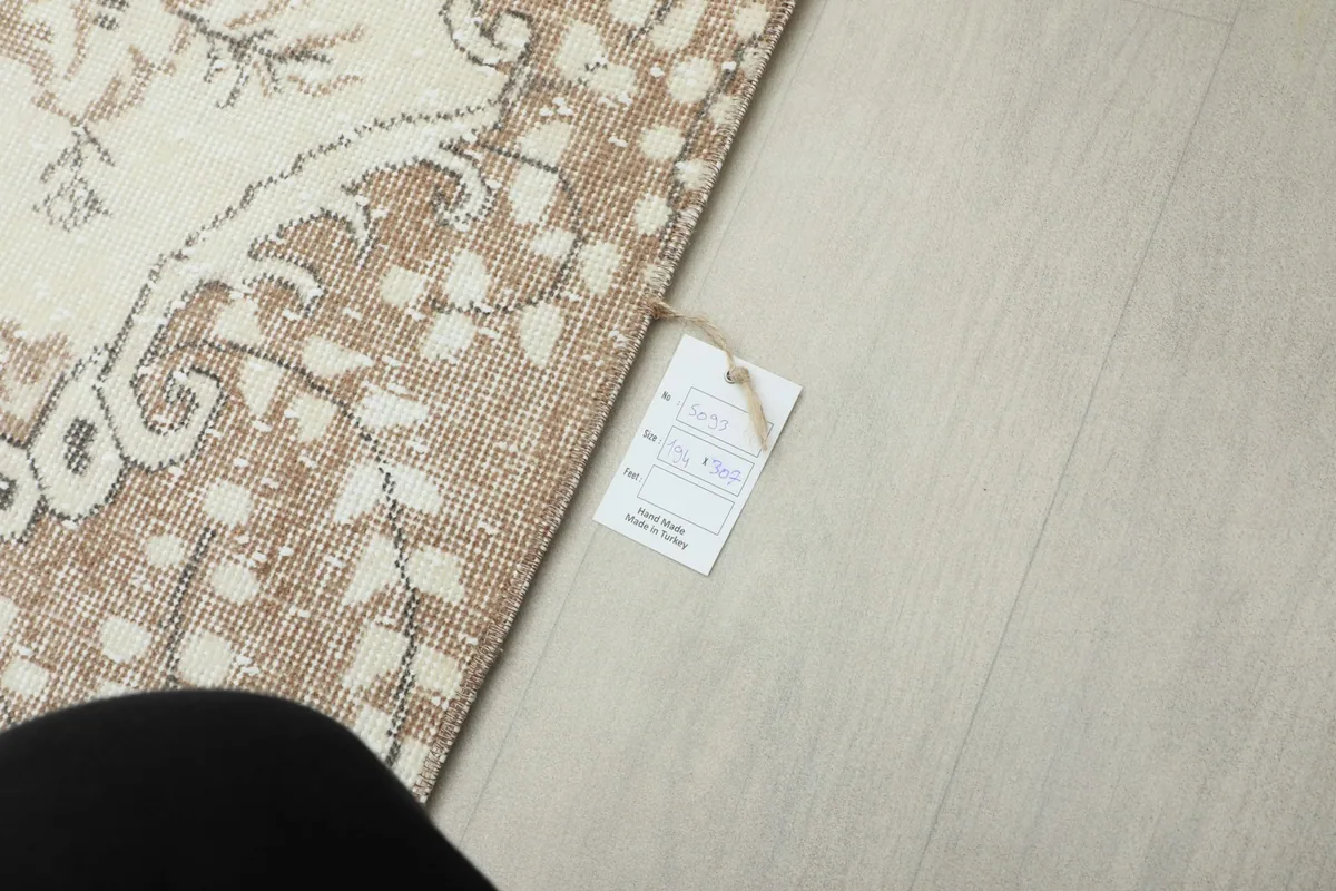 Corner of the rug with a product tag, indicating its origin and materials