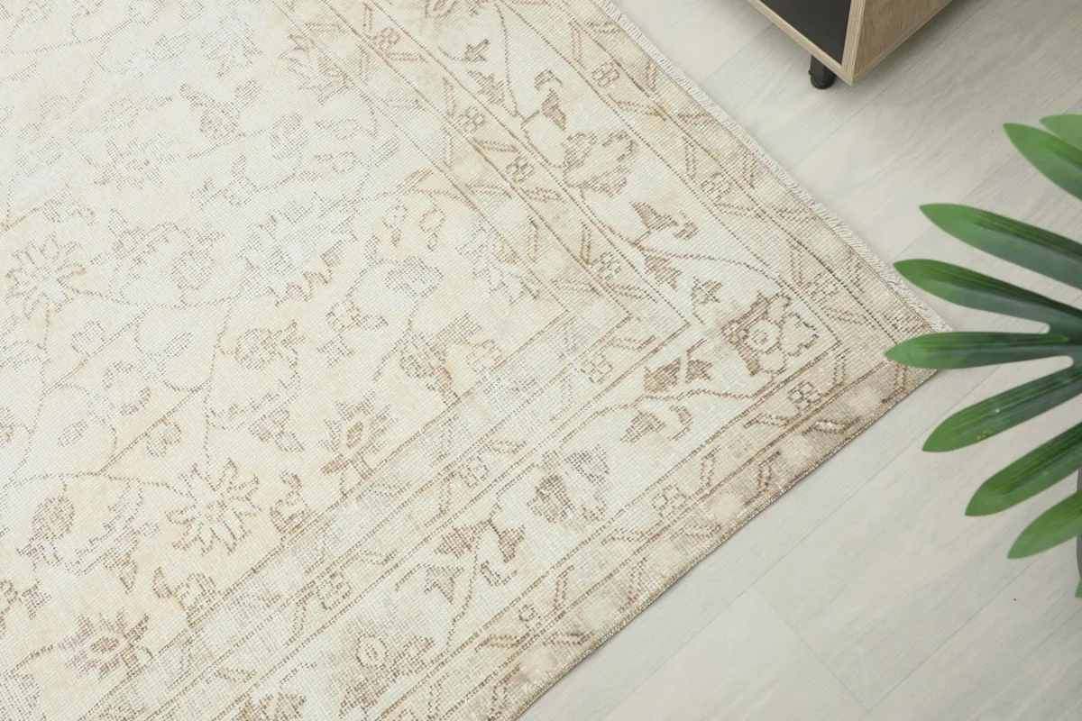 Corner view of the rug, showing the detailed border design with floral elements