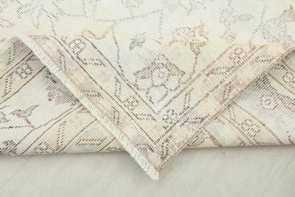 Folded corner of the rug, showing the pliable nature of the vintage wool pile