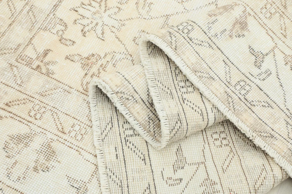 Multiple folds of the rug, illustrating its soft texture and the slight variations in color