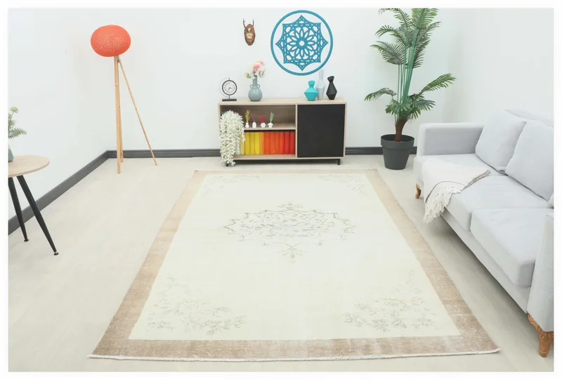 Full top view of the cream floral medallion vintage Anatolian rug on a white background.
