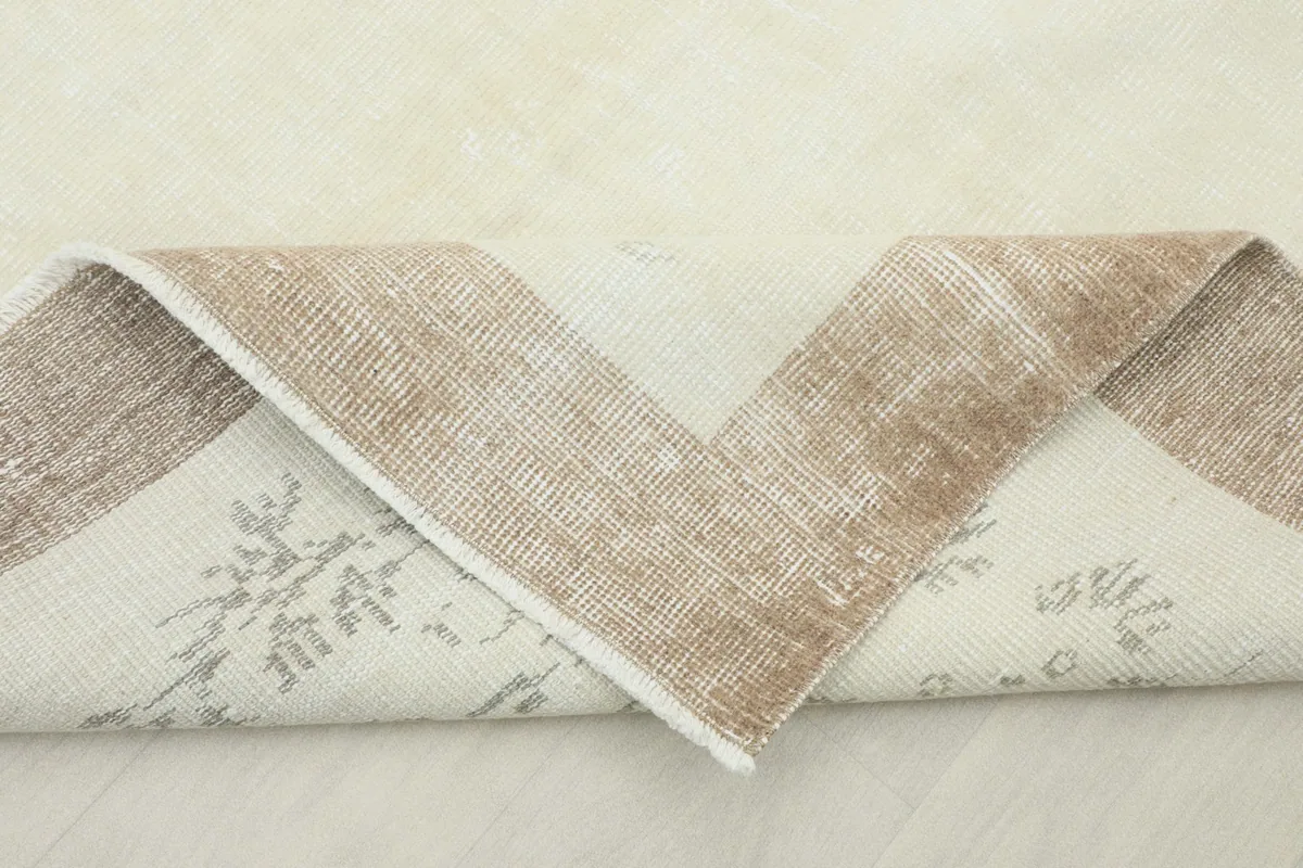 View of the back of the vintage hand-knotted rug, revealing its cotton foundation and knotting.