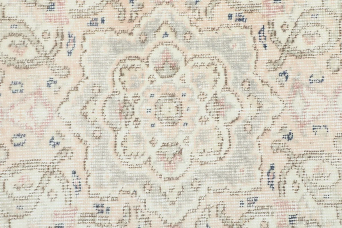 Close-up of a secondary floral motif within the rug's design, showing rose and blue tones