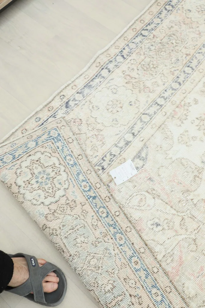 Underside view of the hand-knotted wool rug, revealing the cotton foundation and construction