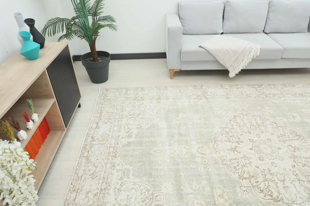 Angle view of the large vintage rug in a living space, showing its scale relative to furniture.