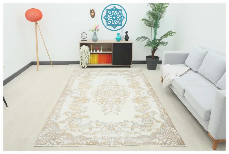 Full top view of the 5'10" x 9'1" ivory gold floral vintage Anatolian rug on a white background.