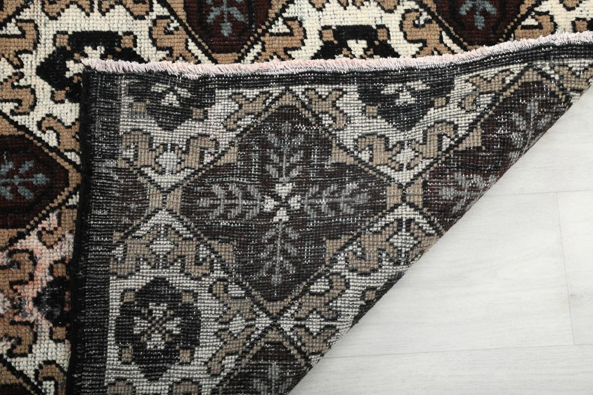 Close-up of the rug's reverse side and hand-knotted construction