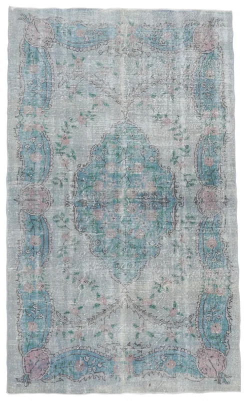 Full top view of the 5'5" x 9'0" vintage Anatolian rug with a gray blue field and central medallion.