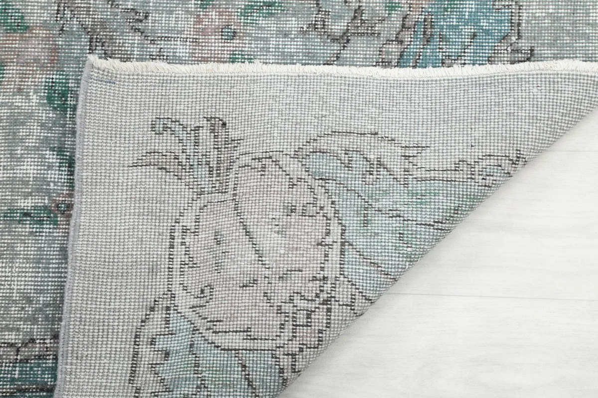 Close-up of the rug's reverse side, revealing the intricate hand-knotting and foundation.
