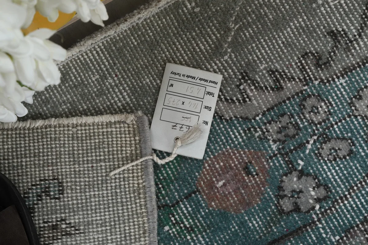 Tag on the back of the rug, indicating its size and origin.