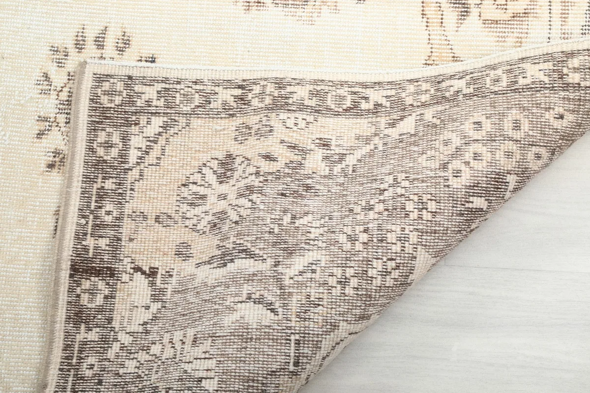 Close-up of the rug's reverse side, showing the intricate hand-knotting and cotton foundation