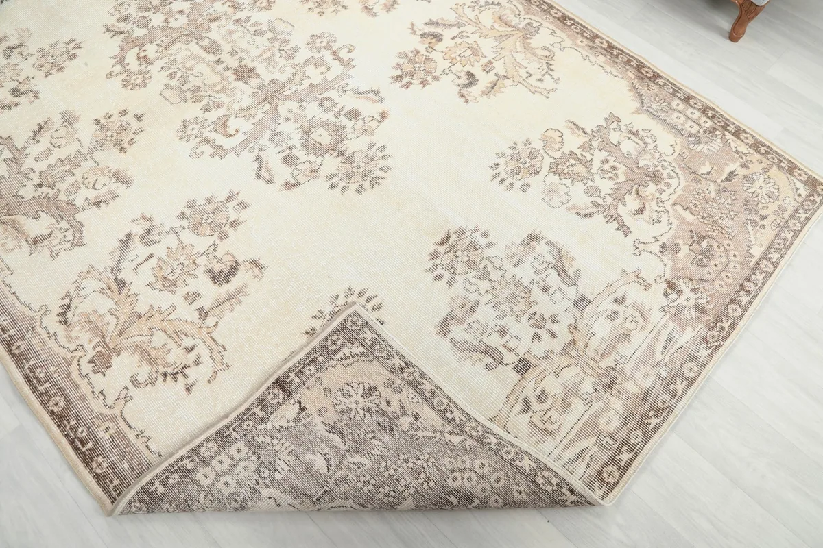 Corner of the rug folded back, revealing the reverse side of the hand-knotted construction