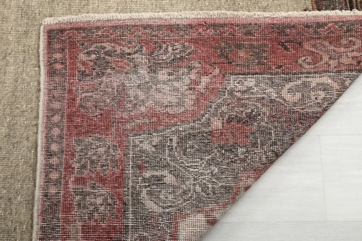 Underside view of the hand-knotted cotton foundation and the reverse of the wool pile