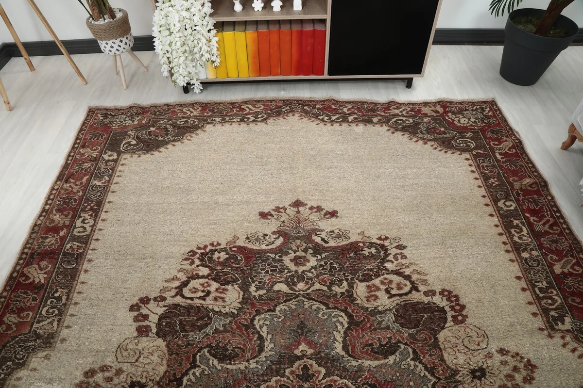 Overhead view showing the full layout of the ivory and red vintage rug in a room