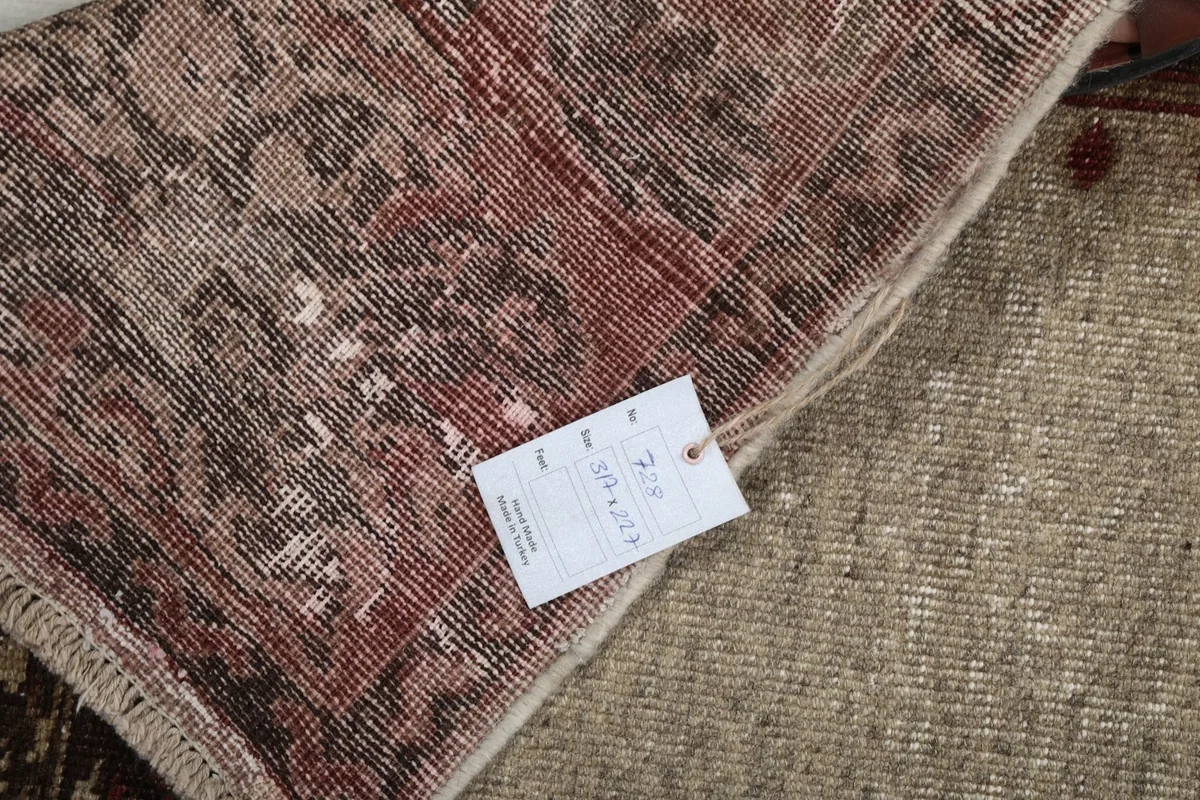 Close-up of the rug's back, showing the tag and detailed hand-knotted construction