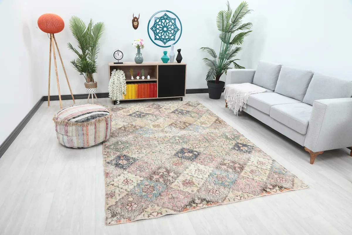 Angle view of the multicolor vintage rug in a living room setting, showing its overall size and pattern