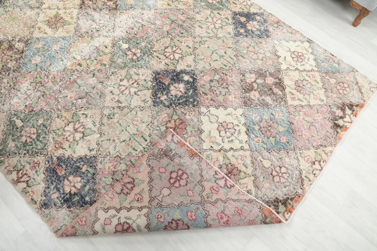Folded corner of the rug, revealing the reverse side and the hand-knotted wool on cotton foundation