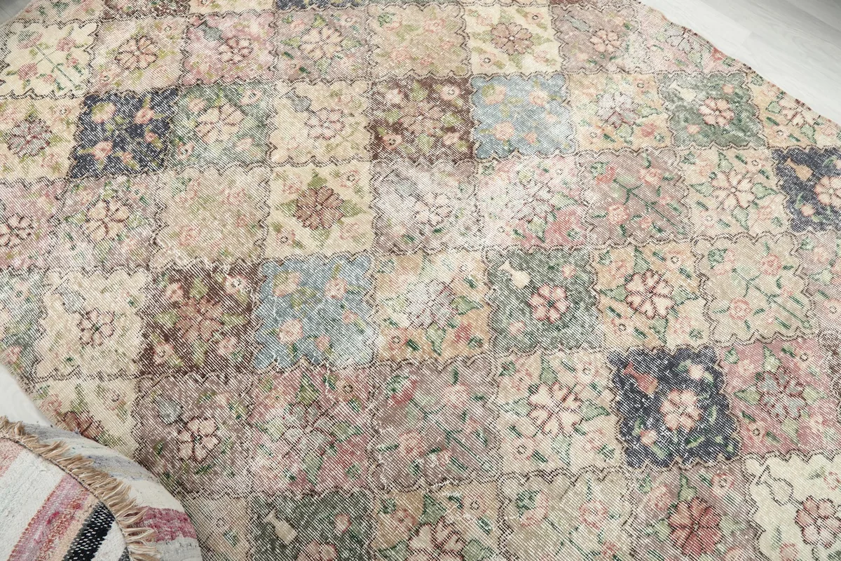 Overhead view of a section of the rug, emphasizing the varied multicolor squares and patterns